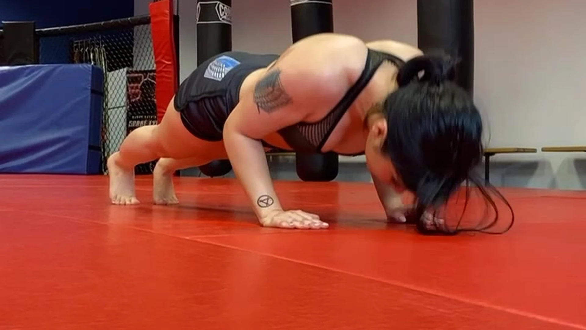 Womanwearingred doing push up in a sexy cloths